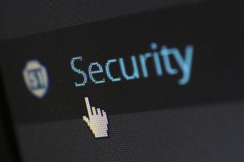 Computer cursor clicking the word "Security" on a digital screen.